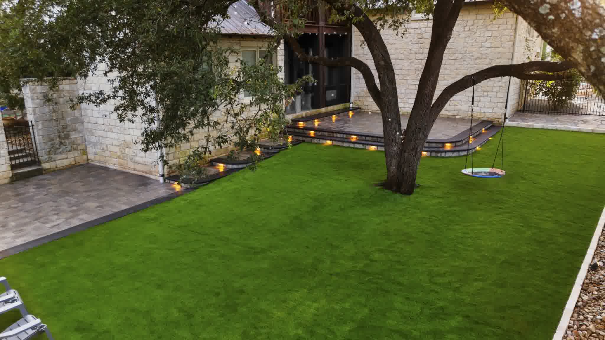 A happy client's backyard after our professionals installed a full artificial turf lawn.